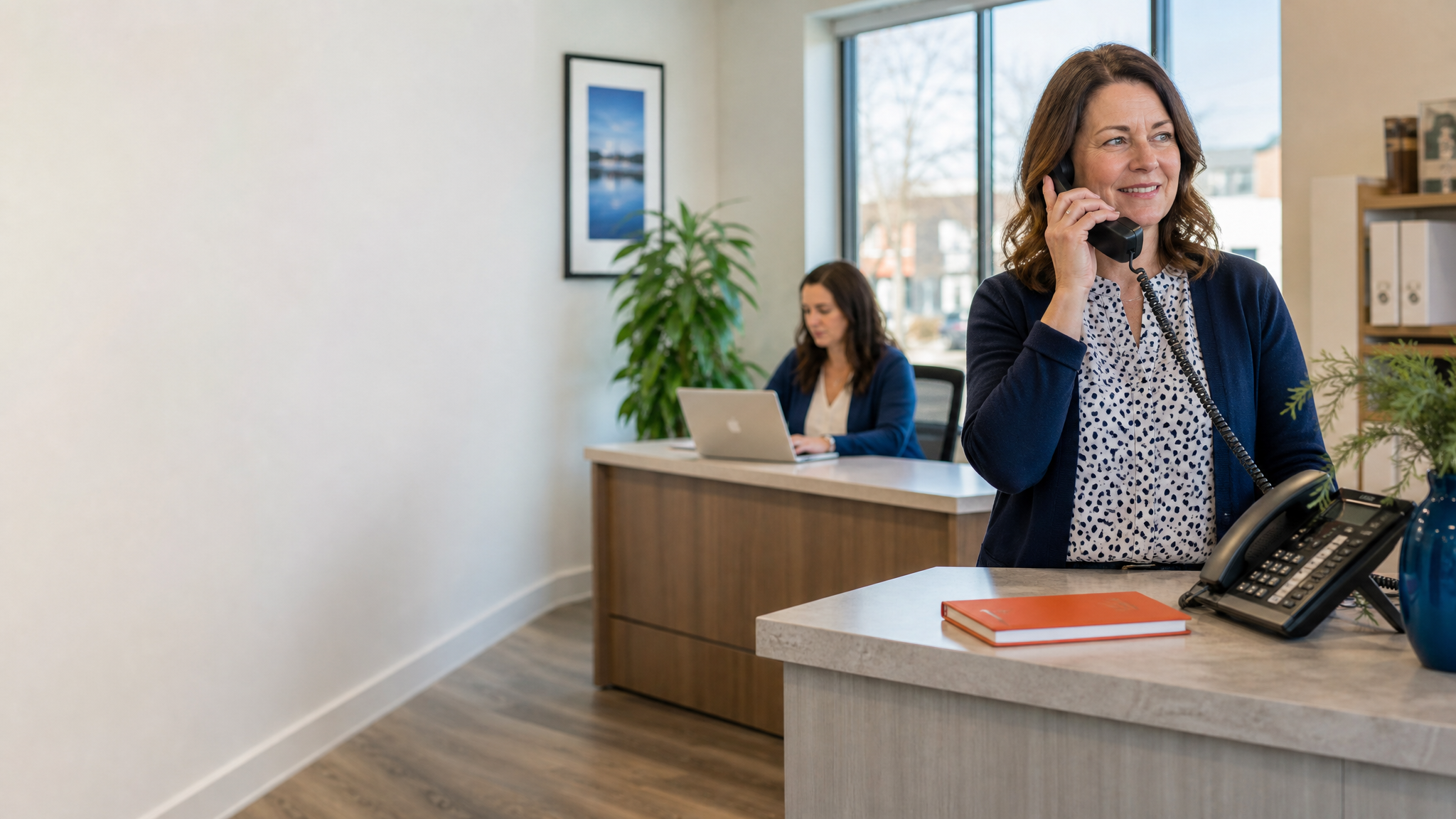 A small-business reception desk, on the phone